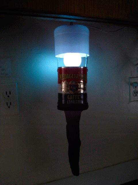 A homemade bug zapper glowing in the dark.