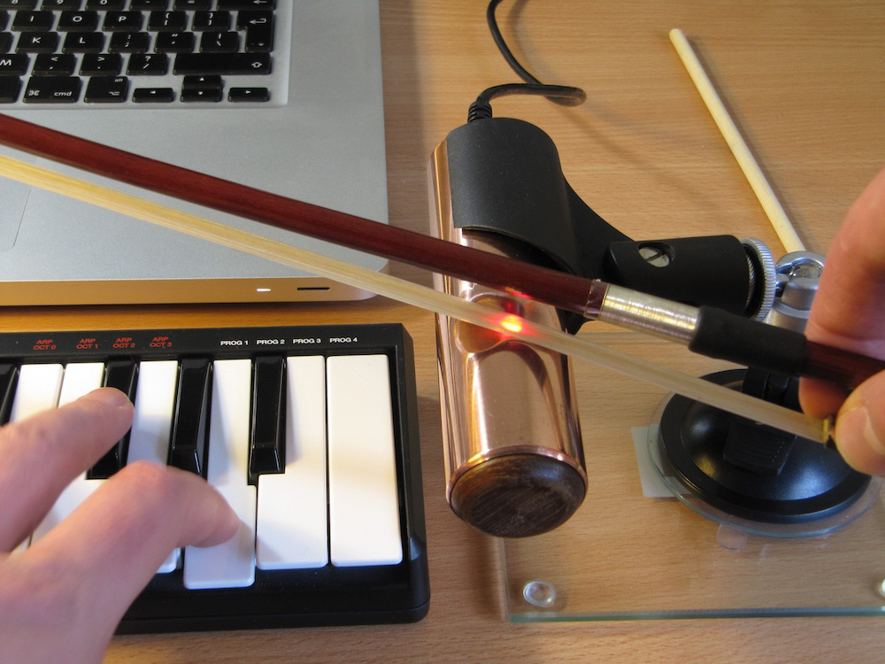 The O-Bow produces a sound by running a regular violin bow over an electronic interface that acts as a violin string. To produce a pitch, the instrument uses a synthesizer that creates an electronic violin sound when pressed simultaneously with the bowing. Here's a quick <a href="https://www.youtube.com/watch?v=xGEpJGnQeQI">demo</a>.