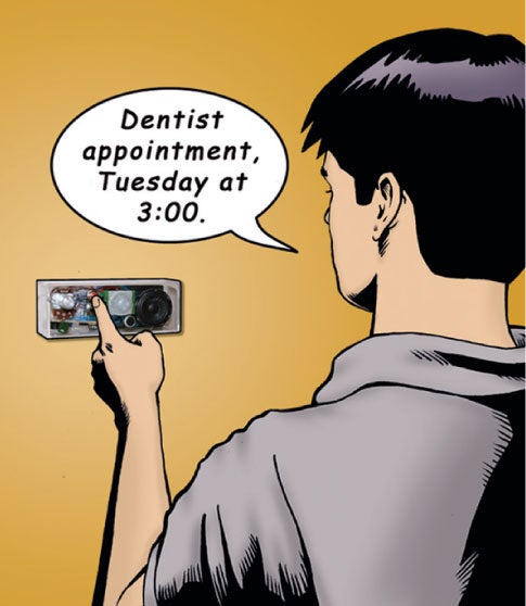 A man wearing a gray polo shirt using a wall-mounted electronic device to record himself saying "Dentist appointment, Tuesday at 3:00."