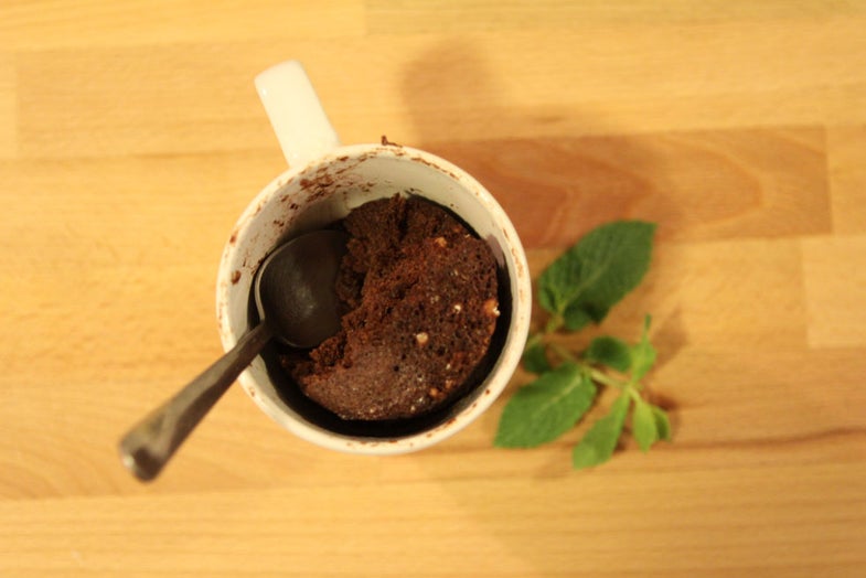 Chocolate cake in a mug with a spoon