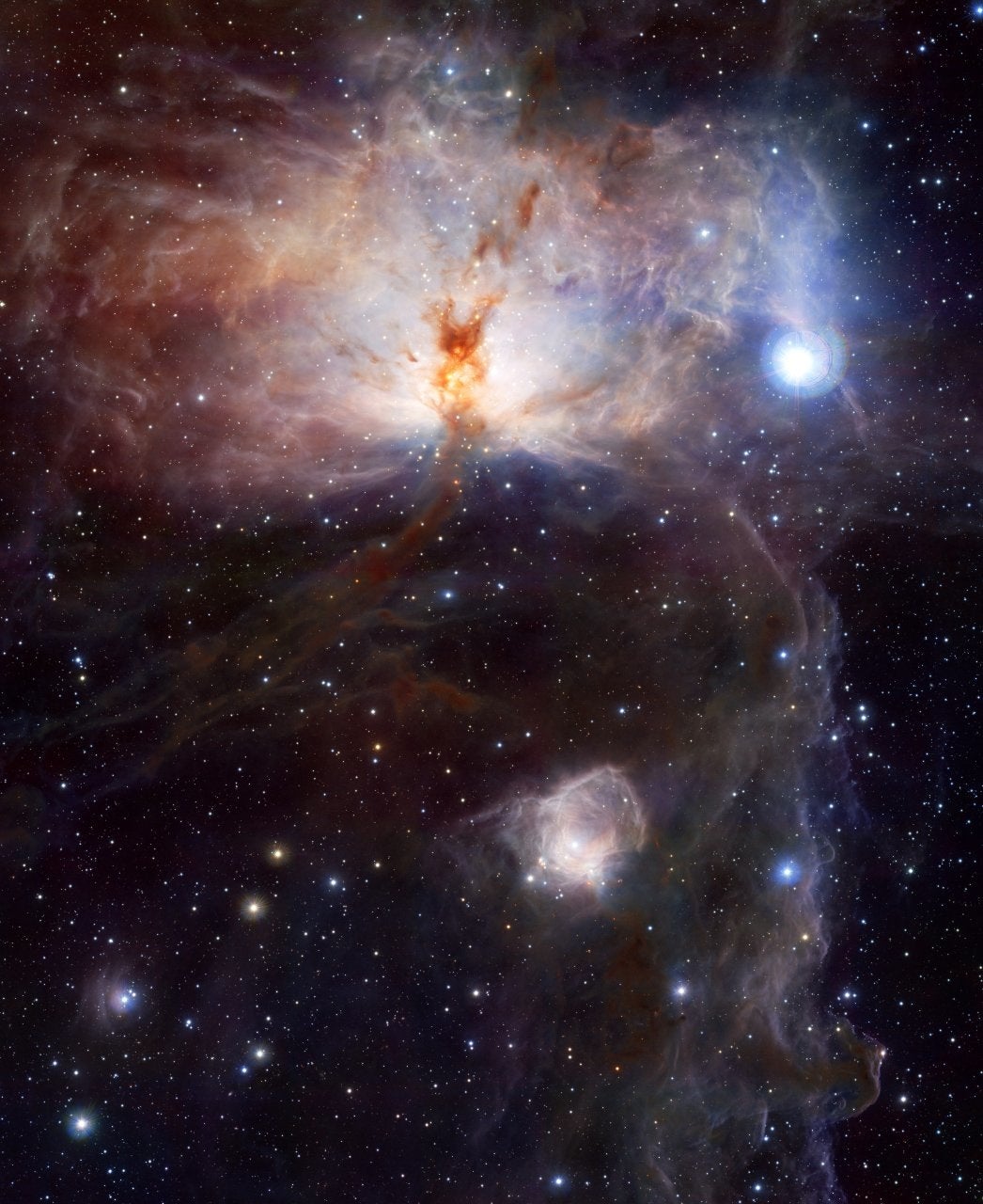 VISTA's first image shows the Flame Nebula (NGC 2024), a spectacular star-forming cloud of gas and dust in the constellation Orion. In visible light, the flame is hidden behind thick clouds of dust, but infrared wavelengths reveal the cluster of hot young stars within.