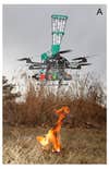 Fire starting drone prototype starting a fire in a field.
