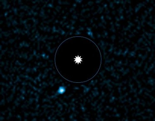 The star itself was removed from the picture during processing to enhance the view of the faint exoplanet, which appears at the lower left.