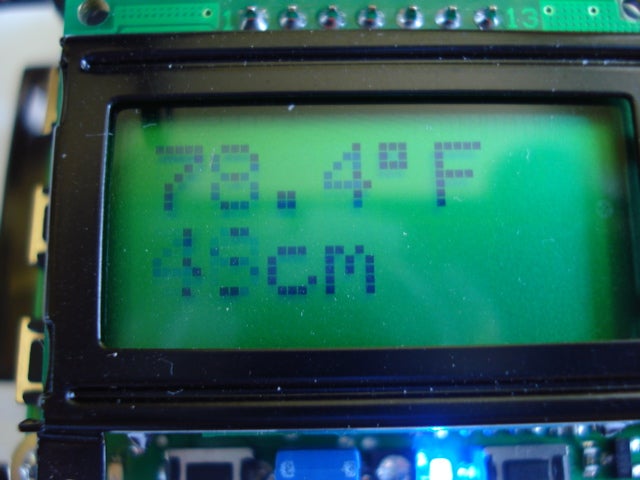 A green LCD screen showing the room temperature at 78.4 degrees Fahrenheit and the distance to the object in front of the truck at 45 centimeters.