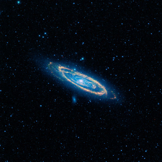 WISE captured the immense Andromeda galaxy, also known as Messier 31 or M31, in this image. Blue highlights mature stars, while yellow and red show dust heated by newborn, massive stars.