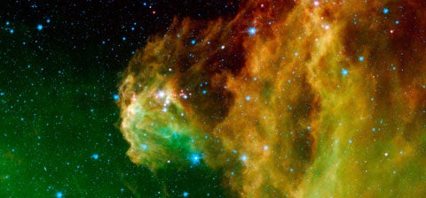 Thirteen hundred light-years away, a three-million-year-old supernova explosion launches a cluster of new stars. Captured by NASA's Spitzer Space Telescope, the birth is visible because of infrared imaging that bypasses dense cloud formations to detect heat-radiating stars, galaxies and planetary systems. As the stars emerge from the Orion constellation, they heat surrounding dust particles (seen in the orange-red areas) and eventually become surrounded by cosmic gas and dust (as are the young pink stars near the top).