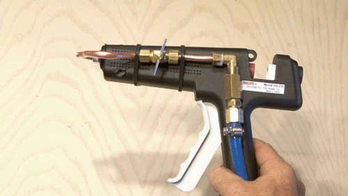 A hot glue gun modified to shoot spider webs for Halloween.
