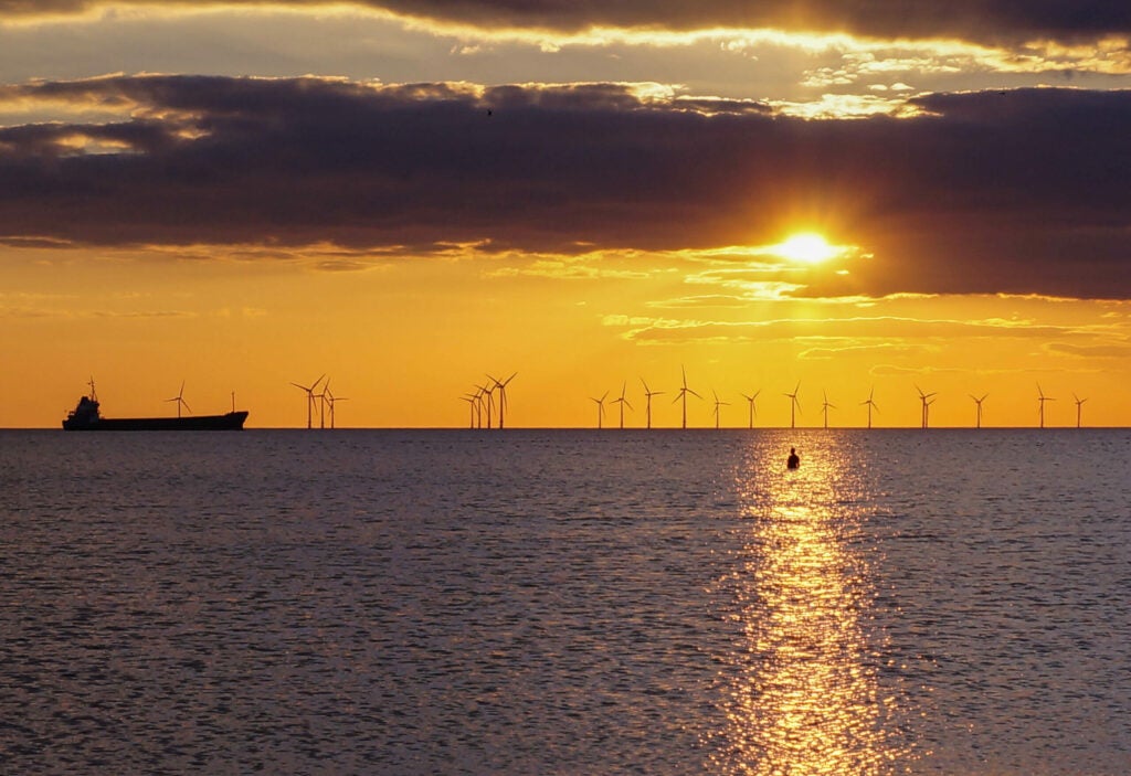 Offshore Wind Turbines at the UK coast at sunset