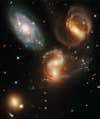 Galactic members of Stephan's Quintet, also known as Hickson Compact Group 92, have tugged and pulled one another out of shape. But studies have shown that NGC 7320, at upper left, is actually a foreground galaxy about seven times closer to Earth than the rest of the group.