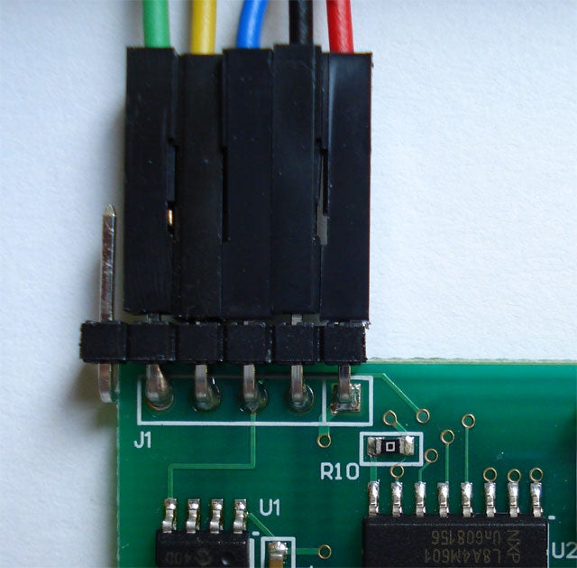 A circuitboard with wires connected to it.