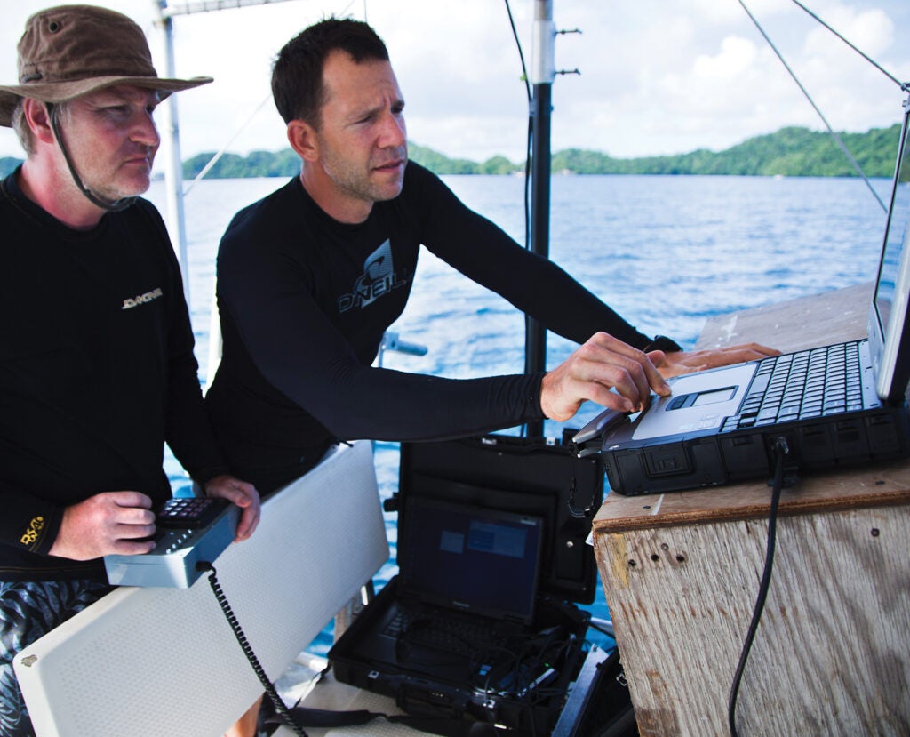 Mark Moline [left] of the University of Delaware pilots a remotely operated vehicle while Eric Terrill of Scripps adjusts sonar and video displays of a sunken Japanese warship.