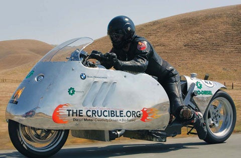 Michael Sturtz rides his custom biodiesel motorcycle in a desert.