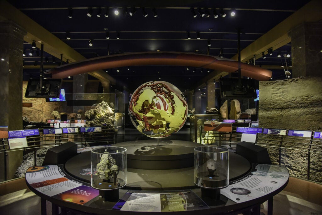 a globe in the middle of a museum exhibit