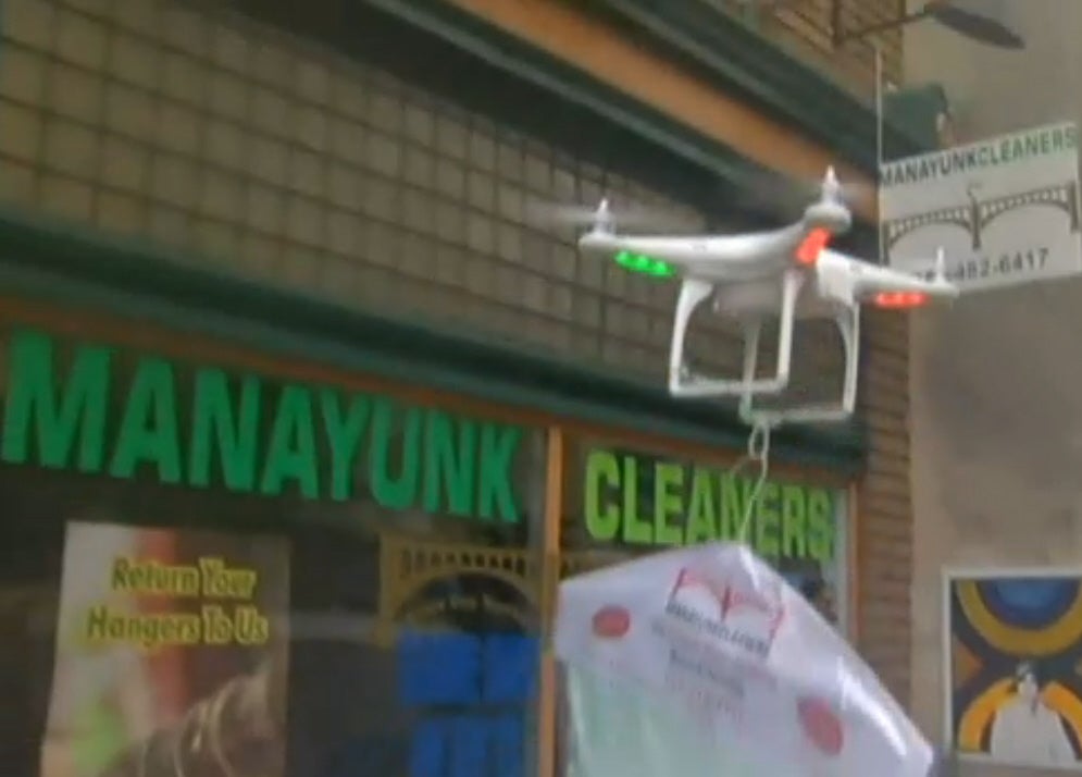 Manayunk Drycleaners in Philadelphia are using a drone for special deliveries. The drone carries a couple of dry-cleaned shirts to a customers within walking distance. With a two-person team, one piloting the drone and the other making sure the pilot doesn't walk into anything, the drones deliver with flair (albeit startling inefficiency). Come 2015, drones capable of carrying more weight, flying farther distances, and perhaps even making multiple deliveries might be a possibility, but for now anyone who wants a robot to deliver clothes will probably still have to tip the two guys walking right behind it.