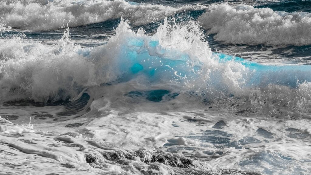 A wave breaks into froth.