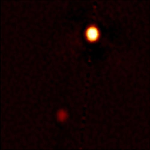 This speckle image reconstruction of Pluto and Charon was obtained in visible light with the Gemini North 8-meter telescope using the Differential Speckle Survey Instrument (DSSI). Resolution of the image is about 20 milliarcseconds rms (root mean square). North is up, east is to the left, and the image section shown here is 1.39 arcseconds across.