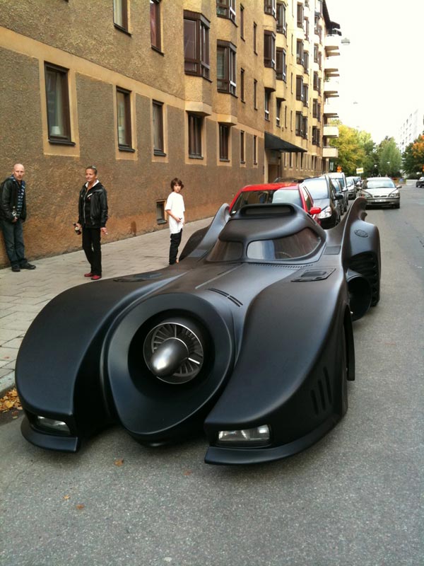 A homemade Batmobile parked on a city street.