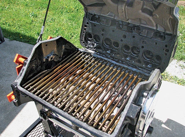 A gas grill with the lid open.