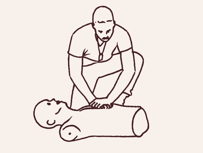 man performs CPR on a dummy