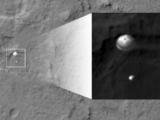 The HiRISE instrument on the Mars Reconnaissance Orbiter snapped this image of the Mars Science Laboratory spacecraft on the chute, sailing toward its perfect landing last night in Gale Crater on Mars.