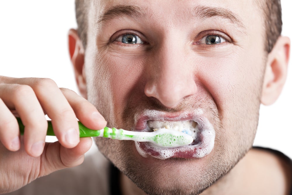 a man brushes his teeth