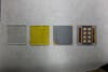 This shot shows the layers of a thin film solar cell. Starting with the plain glass on the left, they add cadmium sulphide (yellow) and then cadmium telluride (black) before arriving at the final product on the right.