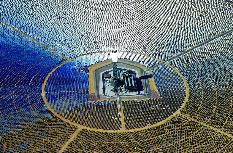 At the Ivanpah solar farm, 347,000 software-controlled mirrors that track the sun's movement throughout the day. They direct light toward one of three towers, where a water boiler creates steam that powers a generator.
