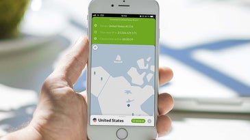 A person holding an iPhone displaying NordVPN for iOS.