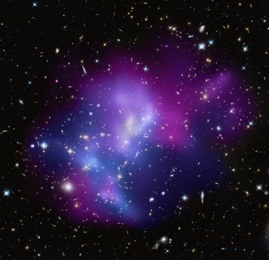 This composite image from the Chandra and Hubble space telescopes shows the massive galaxy cluster MACS J0717.5+3745 (MACS J0717, for short), where four separate galaxy clusters have been involved in a collision. The repeated collisions are caused by a 13-million-light-year-long stream of galaxies, gas, and a dark matter filament pouring into a region already full of matter. Dark matter is thought to greatly contribute to the large-scale structure of the universe.