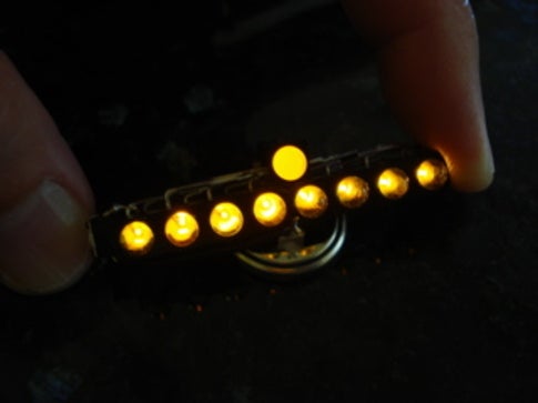 An illuminated LED menorah, with yellow lights.
