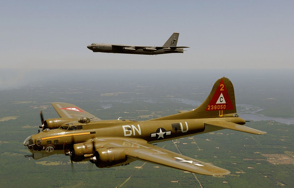In the foreground in the B-17 Flying Fortress, iconic World War II bomber. In the background is a B-52 Superfortress, iconic Cold War bomber still in service.