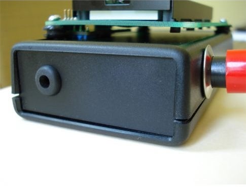 A black plastic box with an LCD screen and circuit board attached.