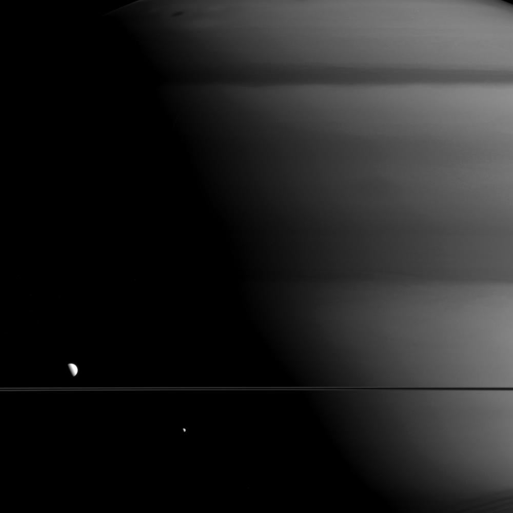 Saturn is seriously humongous. Its moons Mimas (right) and Dione (left) are tiny compared to Saturn, which looms in the background of this picture. For comparison, Dione is about the width of Texas. The spacecraft Cassini snapped this photo at a distance of 634,000 miles from Saturn back in May, but NASA just released it on <a href="http://saturn.jpl.nasa.gov/photos/imagedetails/index.cfm?imageId=5220">Monday</a>. Cassini left Earth in <a href="http://www.nasa.gov/pdf/59910main_cassini.pdf">1997</a> and has been surveying Saturn since 2004.