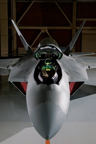 This is one of the first FA-22´s that was delivered to the Nellis AFB in Las Vegas, NV. I photographed it in a hangar with 30,000 watts of strobe lighting. The temperature that day was 110 degrees F! The pilot was fully suited up so I only had 10 minutes to make the photographs once he was in place. He´s holding a green strobe to mimic the heads-up display.
