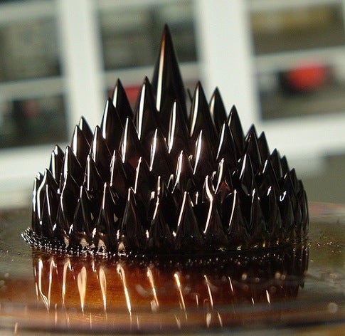 Ferrofluid forming a pile of conical shapes.