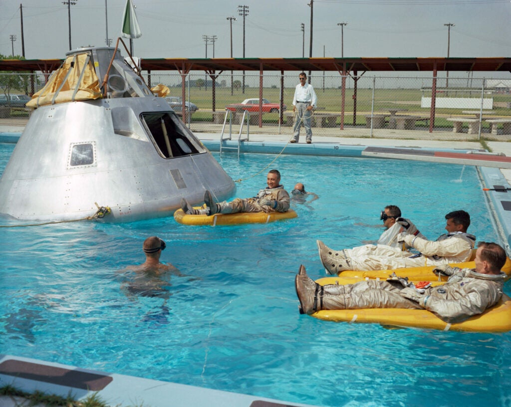 Apollo crew members practicing for their mission in a pool