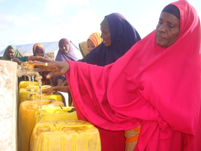 Hawo and other Somali refugees collect clean water.