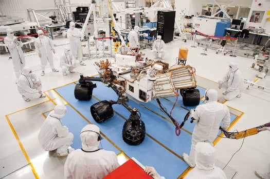 NASA engineers work on the Mars rover Curiosity in a clean room to prevent cross-planetary contamination.