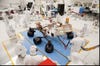 NASA engineers work on the Mars rover Curiosity in a clean room to prevent cross-planetary contamination.
