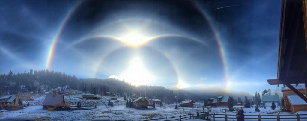 A photographer in Red River, New Mexico, captured this set of rainbow-like ice halos. They are caused when light runs into ice crystals in the atmosphere.