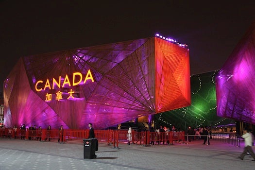 Canada's pavilion is a nice wood-paneled hue by day, representing all those, you know, forests. And by night it's illuminated vividly. Fellow Americans, don't you hate being beaten in the great pavilion race by our northern neighbors? Hat's off, Canadian readers!