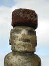 an easter island statue with a large rock hat