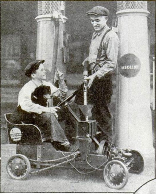 Two boys at a gas station filling up a go-kart-like vehicle they made from a washing machine, in Popular Science magazine. The boy in the driver's seat has a black dog.