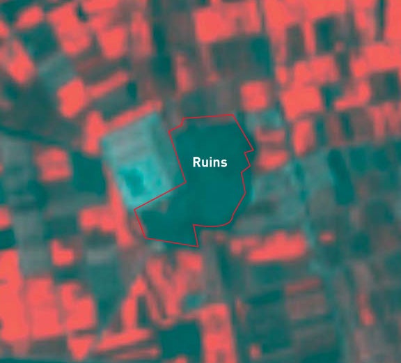 A zoomed-in view of the image reveals a subtle green mound among the red fields. The white square is a water-treatment plant.
