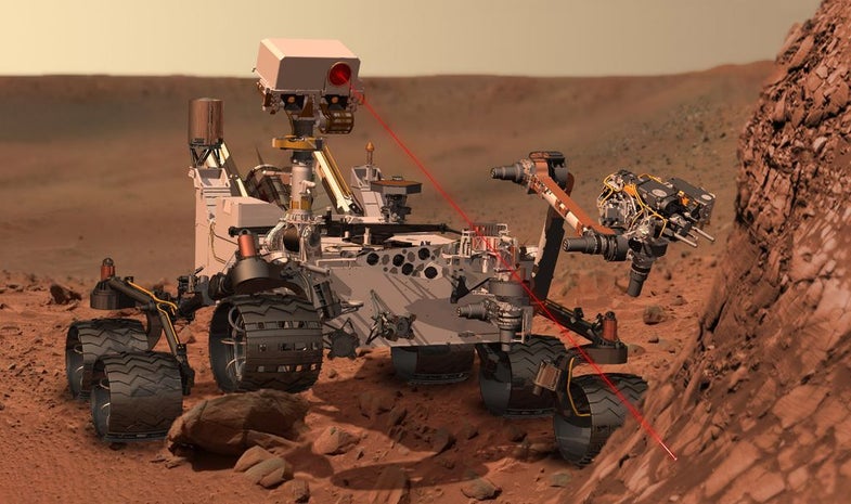 This artist's concept depicts the Curiosity rover using its Chemistry and Camera (ChemCam) instrument to investigate the composition of a rock surface. ChemCam fires laser pulses at a target and views the resulting spark with a telescope and spectrometers to identify chemical elements. The laser is actually in an invisible infrared wavelength, but is shown here as visible red light for purposes of illustration.