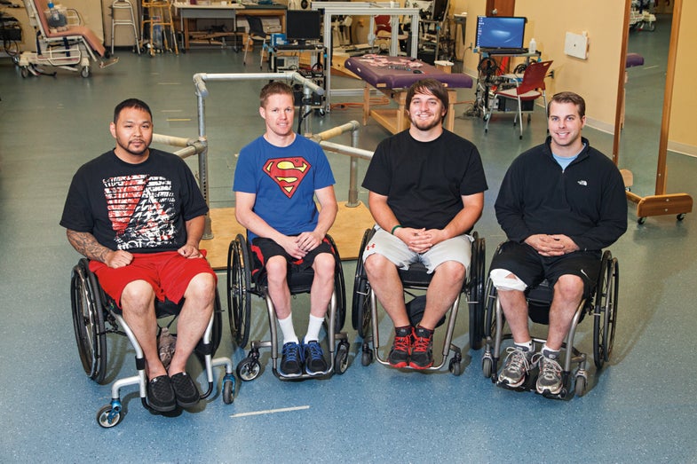 Andrew Meas, Dustin Shillcox, Kent Stephenson and Rob Summers in the University of Louisville lab where they get specialized training to work with electrical stimulation to move parts of their bodies below their spinal cord injuries.