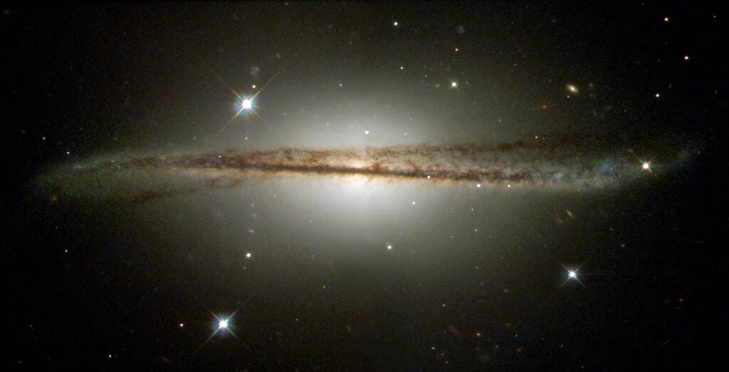 An edge-on galaxy that curves downward on the left