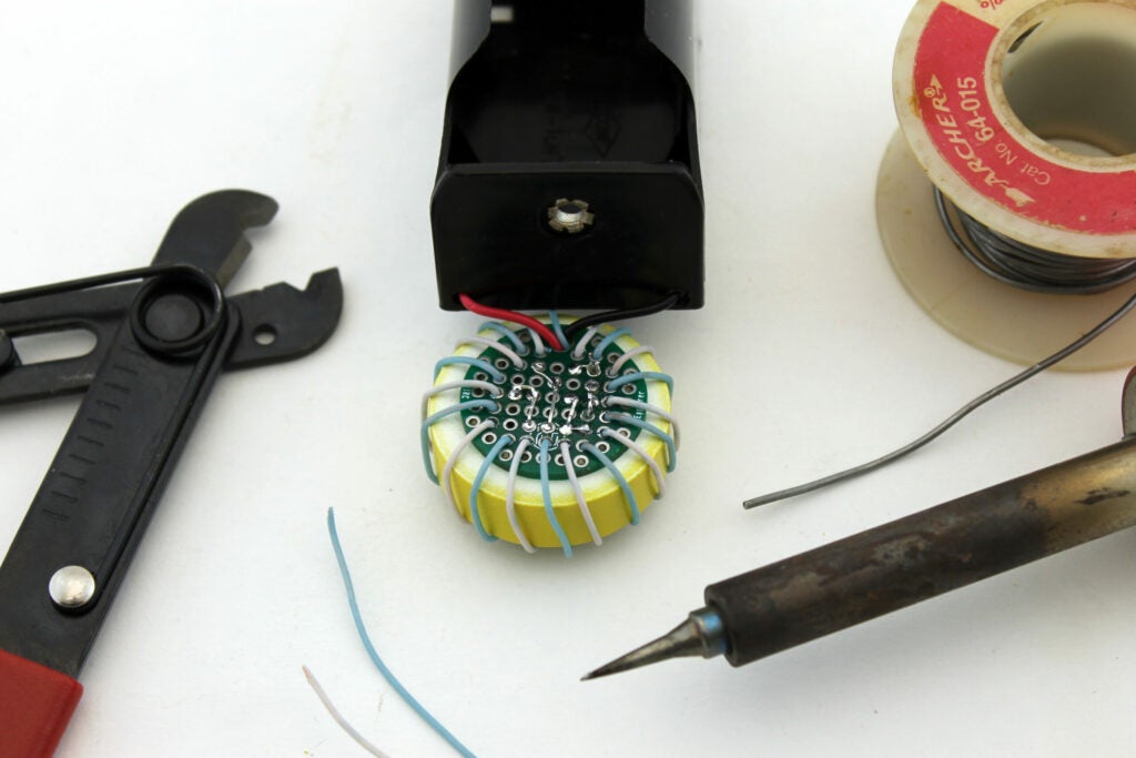 Solder toroid wires to board