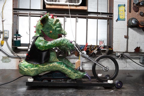 A green hog demon on a power tool motorcycle.
