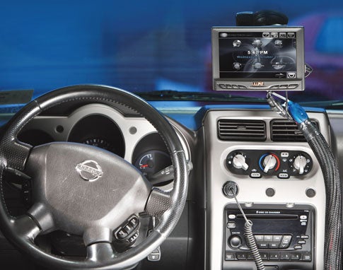 A dashboard-mounted computer in a car.
